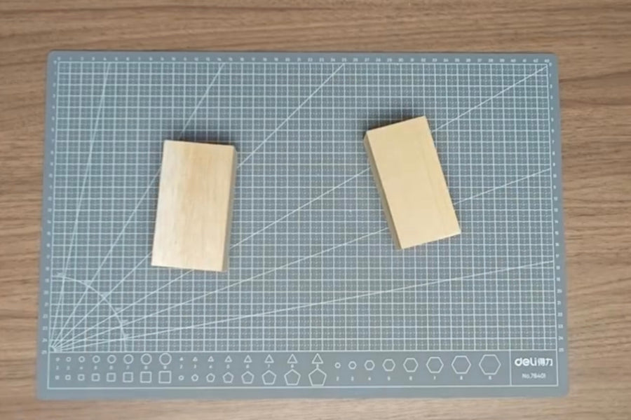 Balsa and basswood blocks side by side on a cutting mat