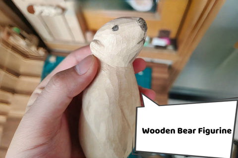 Finished natural-wood bear with a lowered head and long arms