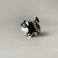 Right side view of the cute dog keychain with the key ring over the dog's tail, showing its size against the key ring.