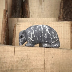 Armadillo wooden figurine on stacked wood blocks