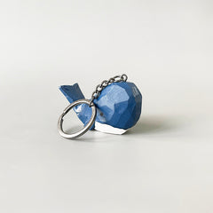 Back view of the big head blue whale keychain, emphasizing its hand-carved details and vibrant dark blue and white paint.