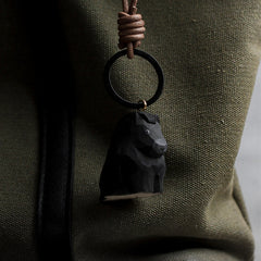 black wooden horse keychain on backpack