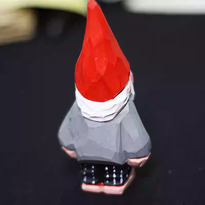 Back view of the Christmas gnome showing the red pointed hat and gray carved body