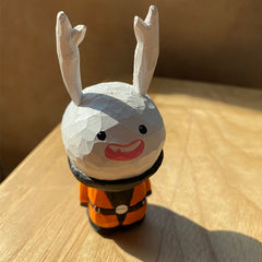 Crafted wooden bunny jester with vibrant colors and a joyful smile.