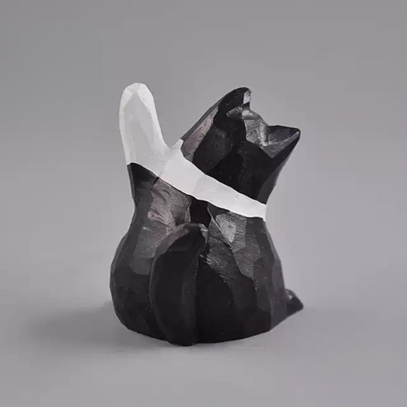Hand carved black and white cat figurine rear view