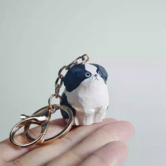 hand carved wooden border collie keychain in hand