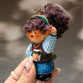 Handcrafted wooden doll keychain holding a coffee cup, carved wood body with curly cotton yarn hair