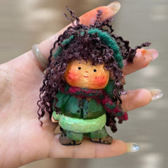 Handcrafted wooden doll keychain with green scarf and curly yarn hair, small wood doll carved by hand