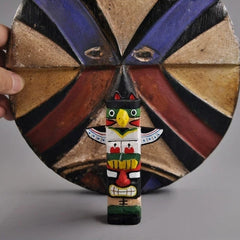 Miniature totem pole figurine with painted shield backdrop