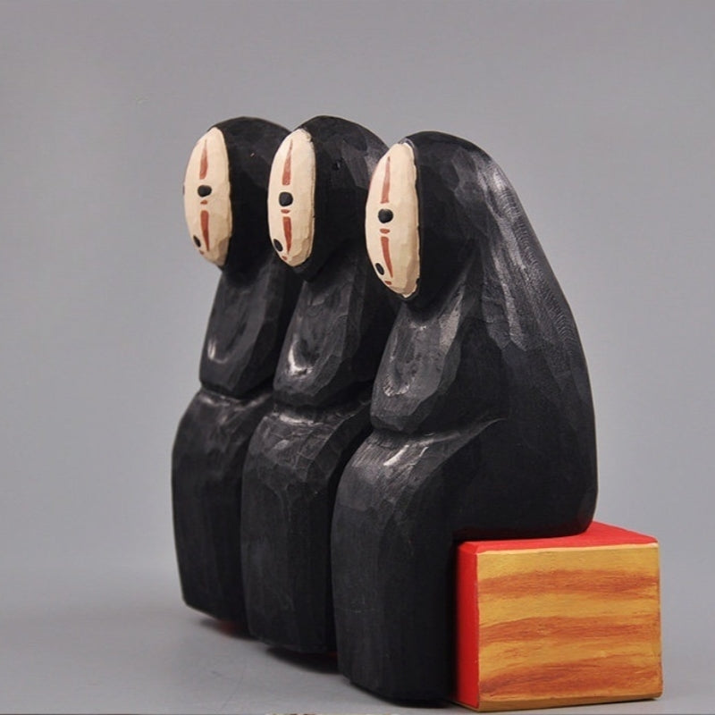 Three No Face Figure wood sculptures aligned side-by-side with identical details.