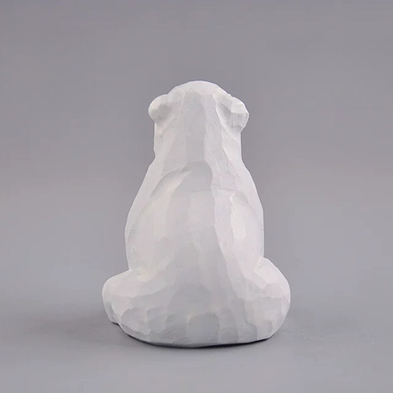 Back view of sitting polar bear wood carving