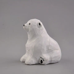 Sitting polar bear wood carving side view