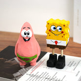 Hand-carved wooden Spongebob Squarepants figure standing next to Patrick Star.