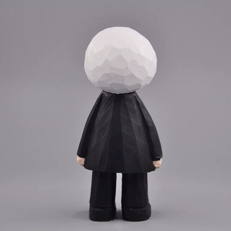 Back view of the eyeball figure showing its faceted white head and black suit