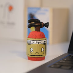 Hand-carved fire extinguisher toy for tabletop decoration.