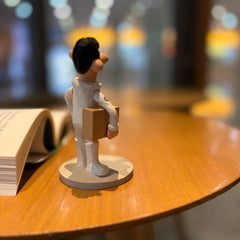 Back view of wooden astronaut figurine showing suit detail