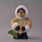 Wooden bear figurine holding a fish wearing winter coat