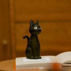 Wooden black cat figurine standing upright