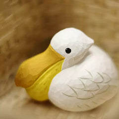 Wooden pelican figurine with carved wing details