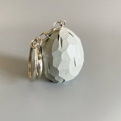 Back view of the carved wooden Zombie Wall-nut keychain showing faceted texture and craftsmanship.