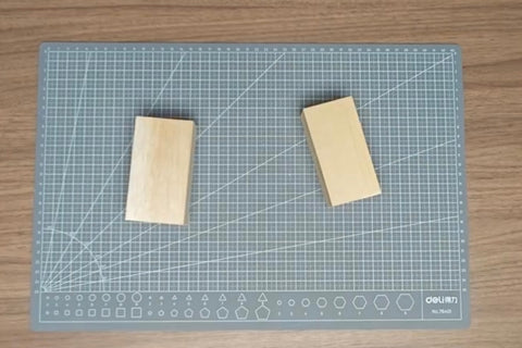 Balsa and basswood blocks side by side on a cutting mat