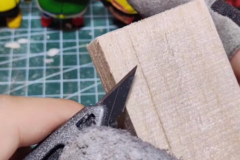 Segmented utility knife positioned against the edge of a wood block
