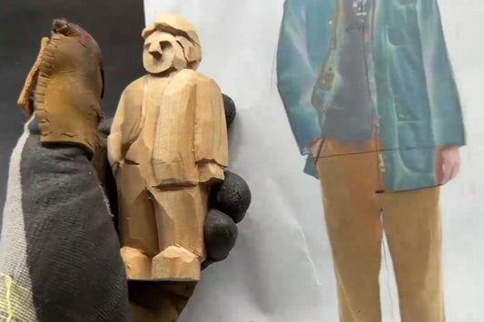 Hand-carving a wooden figurine with coat and collar details for personalized wooden gifts