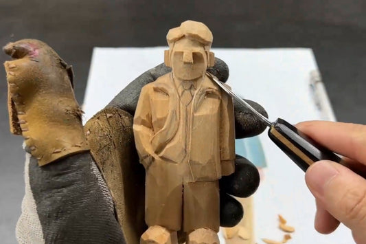 Detail carving of a handmade figurine’s shoulder, highlighting craftsmanship in creating wooden gifts with layered depth.