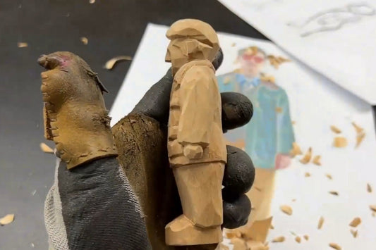 Side view of a hand-carved wooden figurine showing layered clothing and pocket details, crafted as part of a wooden gifts tutorial.