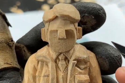 Wood carving figure in progress, part of a wooden gifts tutorial focusing on layered clothing details like vest and tie.