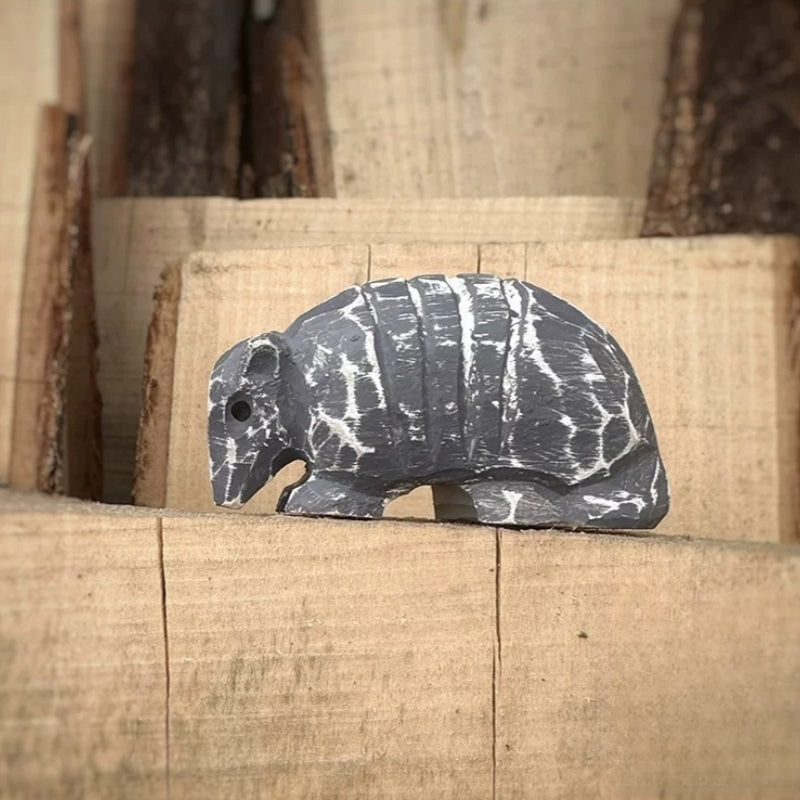 Armadillo wooden figurine on stacked wood blocks