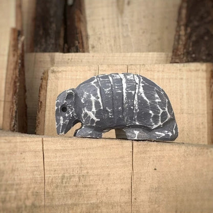 Armadillo wooden figurine on stacked wood blocks