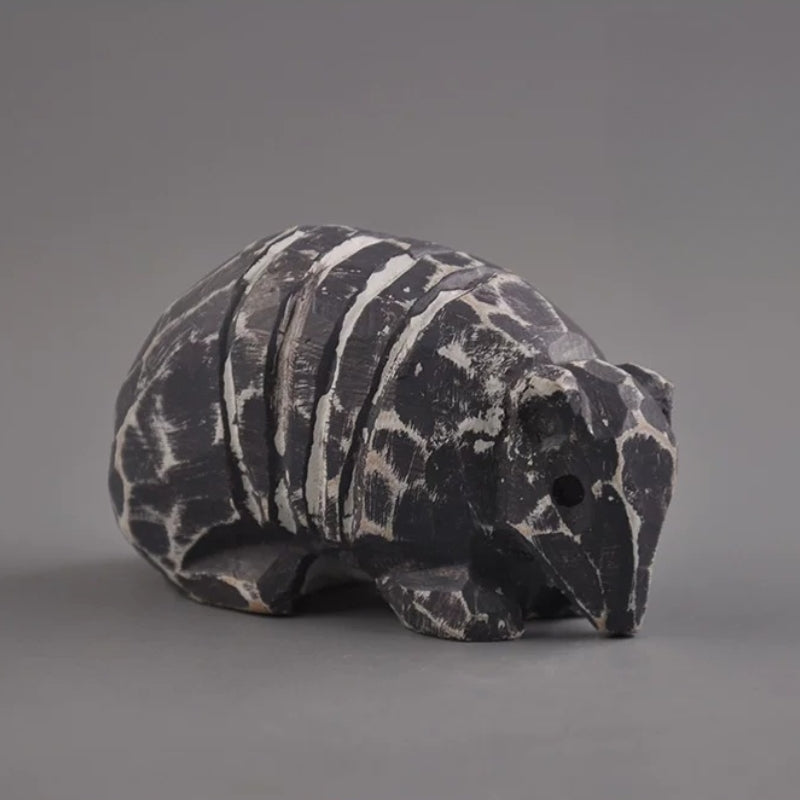 Three-quarter view of armadillo figurine showing snout and shell