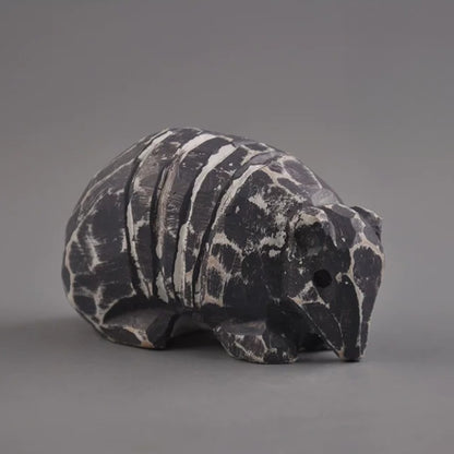 Three-quarter view of armadillo figurine showing snout and shell