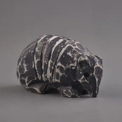 Three-quarter view of armadillo figurine showing snout and shell