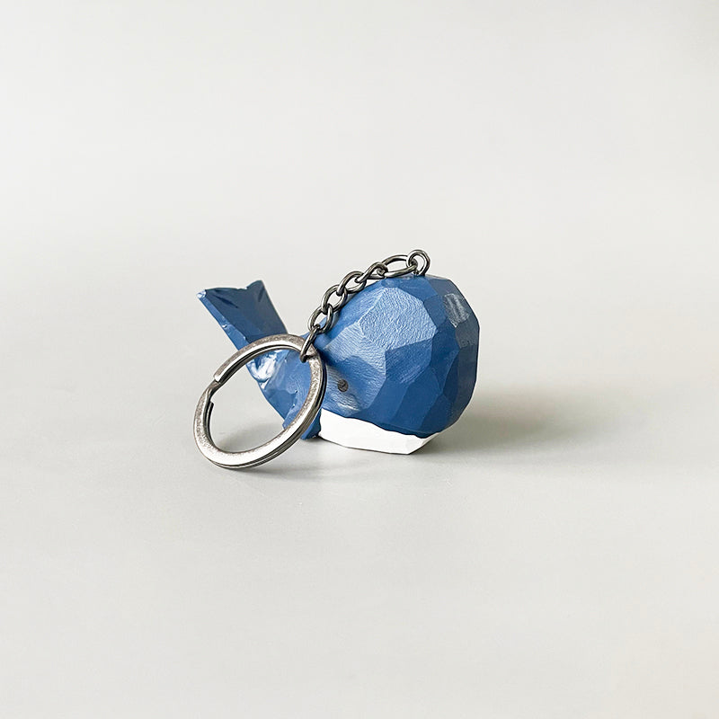 Back view of the big head blue whale keychain, emphasizing its hand-carved details and vibrant dark blue and white paint.