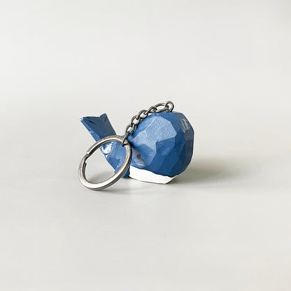 Back view of the big head blue whale keychain, emphasizing its hand-carved details and vibrant dark blue and white paint.
