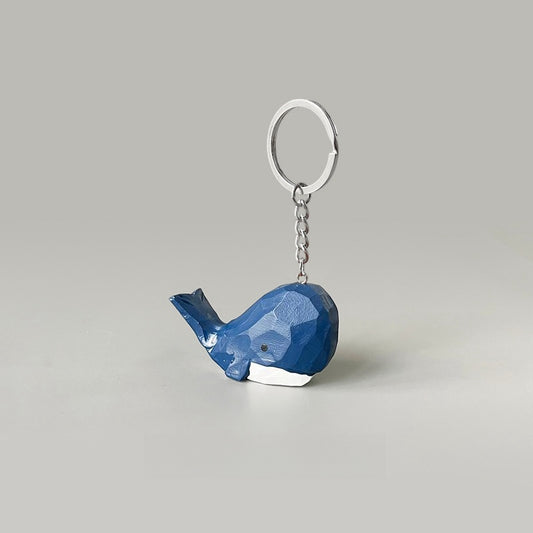 Hand-carved big head blue whale keychain, featuring a cartoon style with dark blue and white colors.