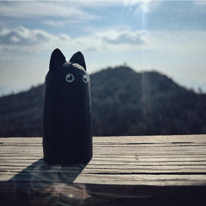 black cat figurine outdoor setting