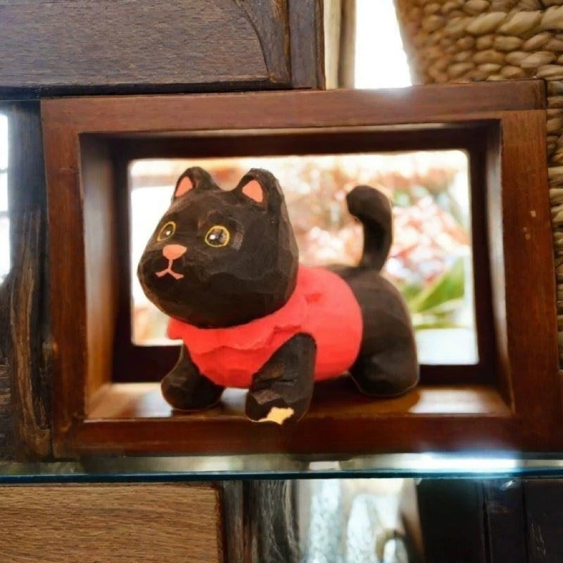 Black kitten figurine in red sweater