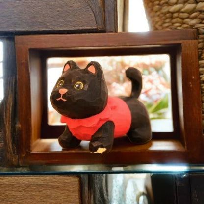 Black kitten figurine in red sweater