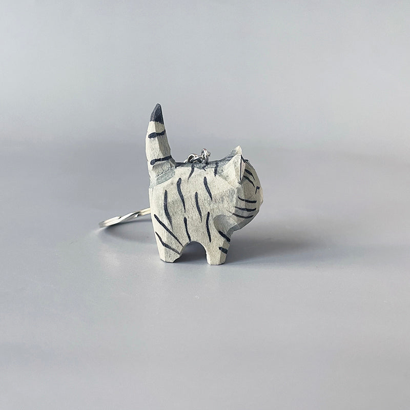 Left side view of black stripe gray cat keychain showing its striped pattern.