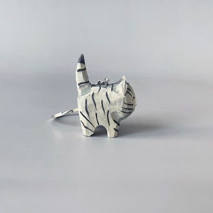 Left side view of black stripe gray cat keychain showing its striped pattern.