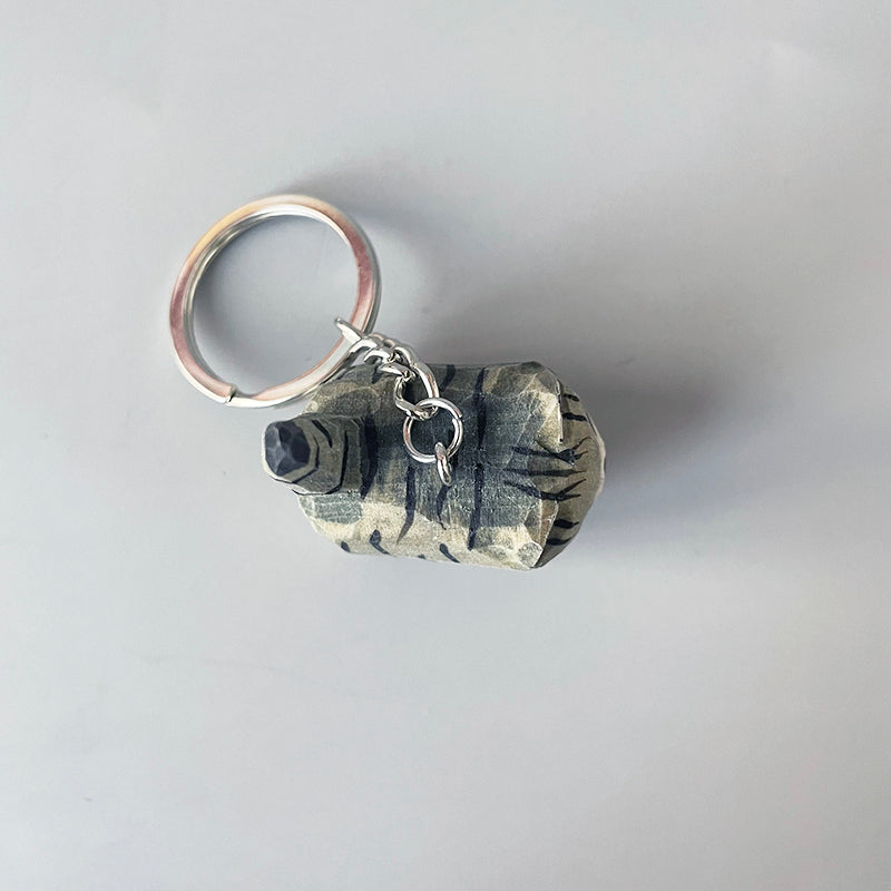 Top view of black stripe gray cat keychain with a metal key ring.