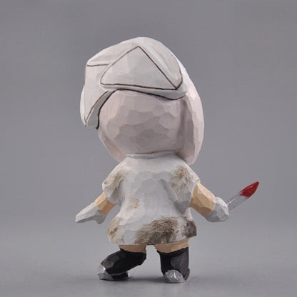 Back of the wooden nurse figurine showing the cap and painted brown stains on the white dress
