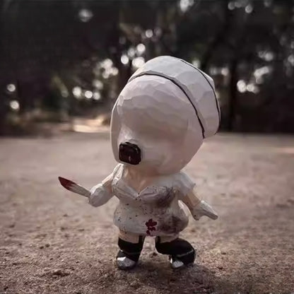 Bubble head nurse wooden figurine displayed on outdoor ground surface