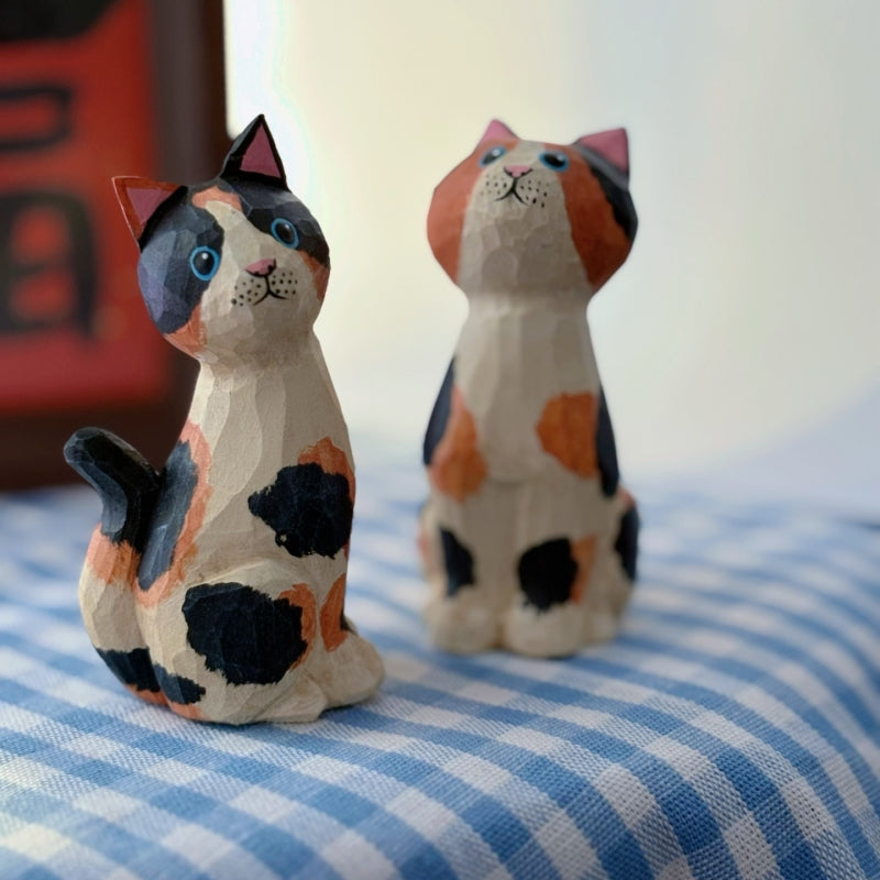 Close view of painted calico pattern on wooden cat figurine