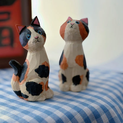 Close view of painted calico pattern on wooden cat figurine
