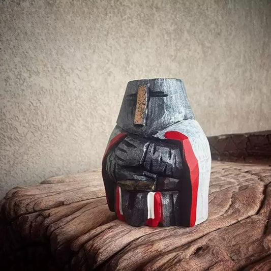 Chibi knights templar figurine on a wooden surface
