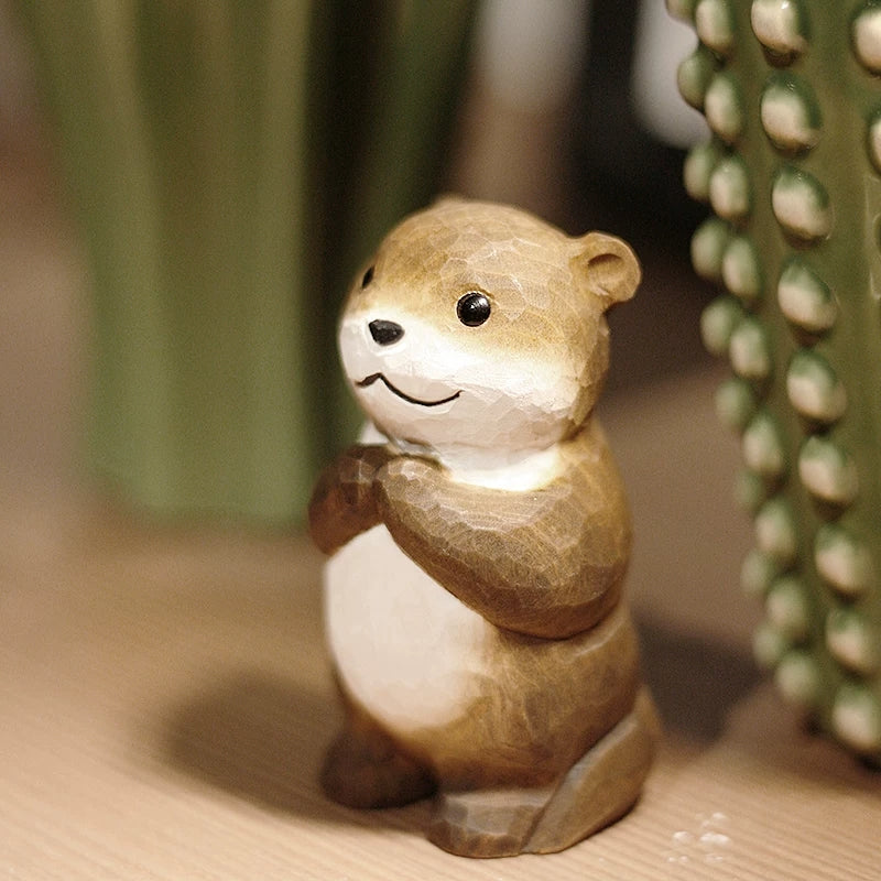 Chibi otter figurine standing beside green cactus